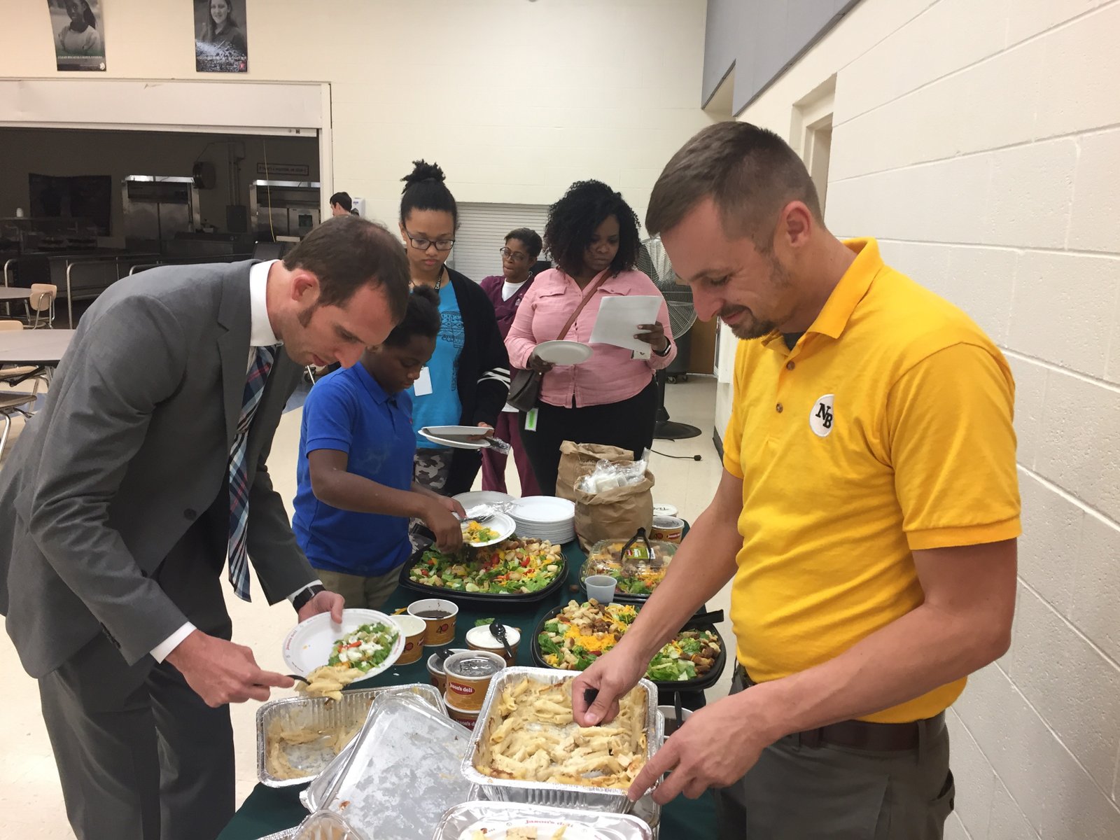 Adam Holdren serving students and families at a school community event