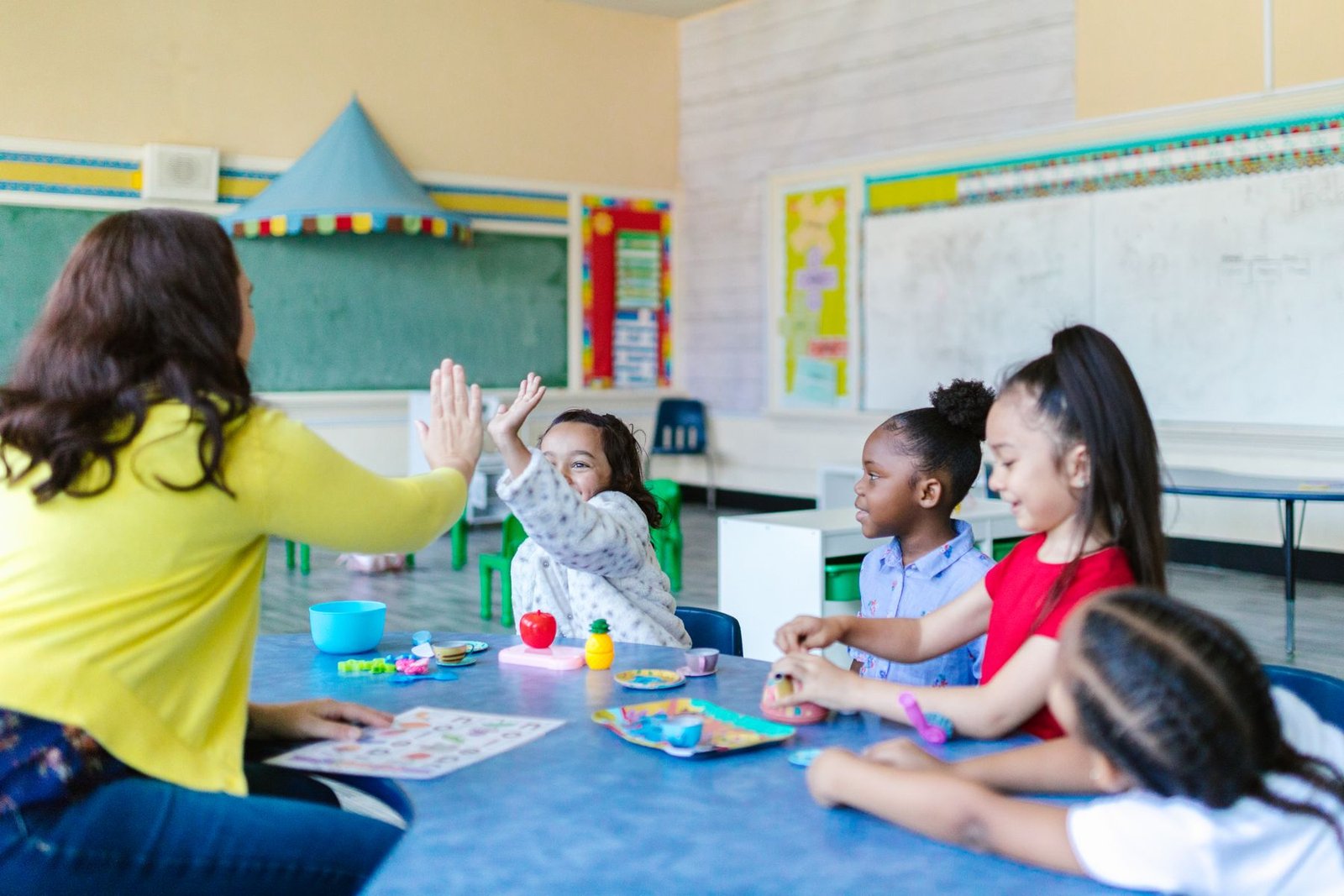 Young students learning through play with their teacher